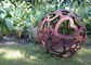 Large Heart Pattern Corten Steel Sculpture Hollow Sphere Metal Garden Ball supplier