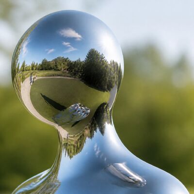 Custom Mirror Polished Stainless Steel Contemporary Figure in a Flowing Coat
